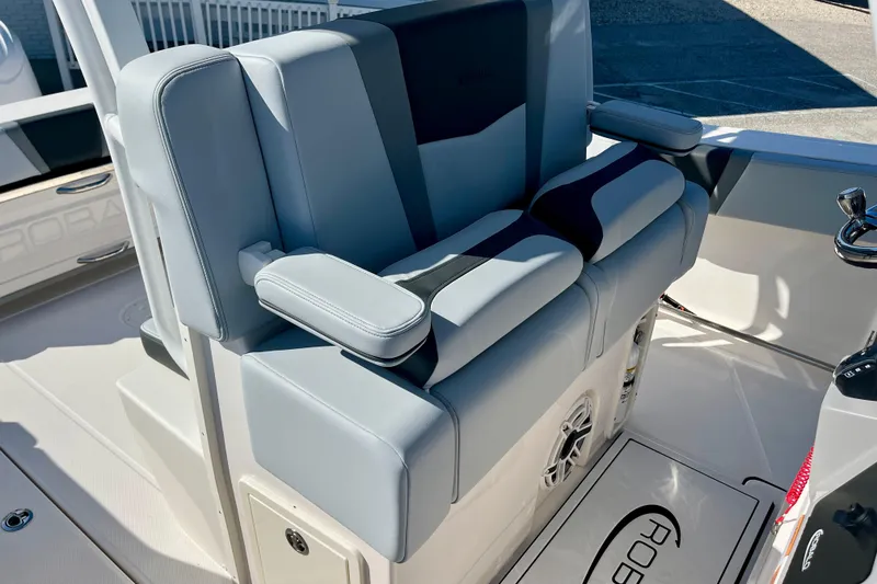Slide: The Image of 2026 Robalo R270 Center Console boat seating area with cushioned armrests. - 28