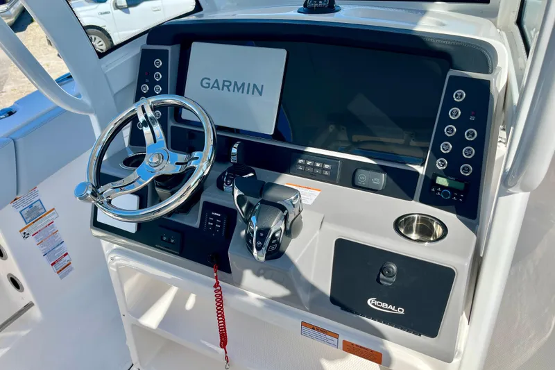 Slide: The Image of 2026 Robalo R270 Center Console helm with Garmin display and modern controls. - 30
