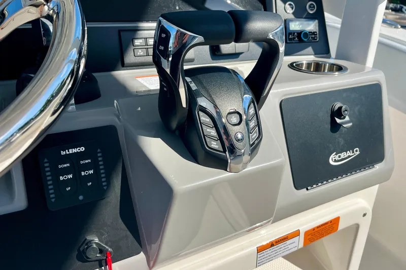 Slide: The Image of 2026 Robalo R270 Center Console boat helm with controls and steering wheel. - 31
