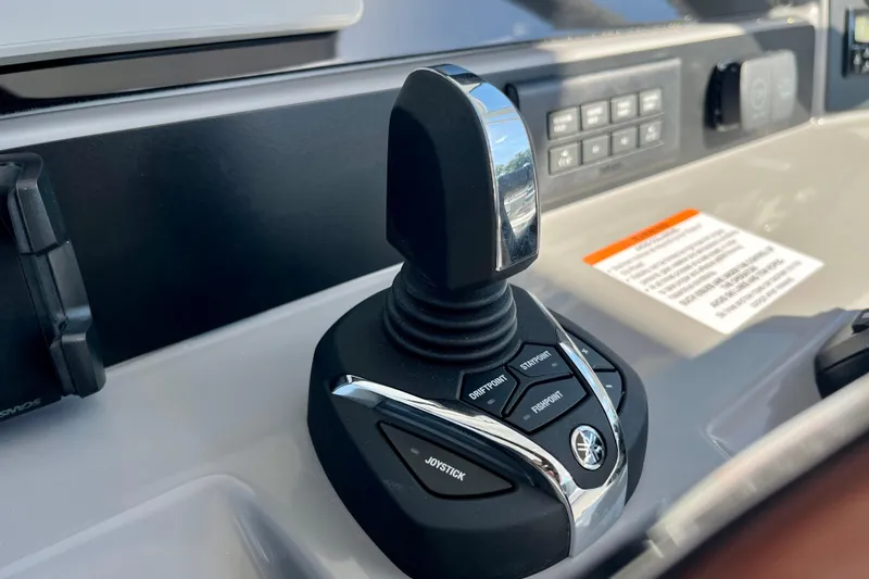 Slide: The Image of 2026 Robalo R270 Center Console joystick control on dashboard. - 32