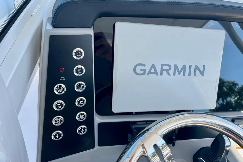 Slide: The Image of 2026 Robalo R270 Center Console dashboard with Garmin navigation system and control panel. - 33