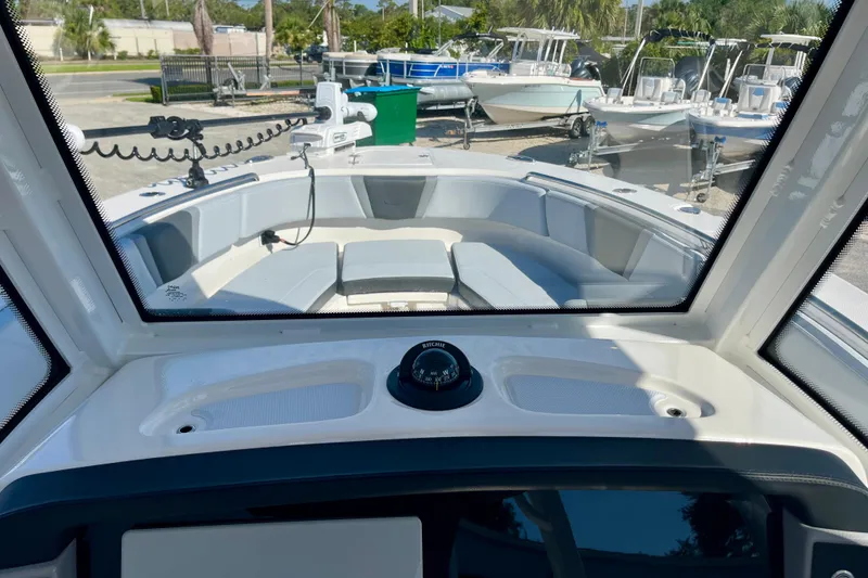 Slide: The Image of 2026 Robalo R270 Center Console boat interior with seating and navigation equipment. - 35