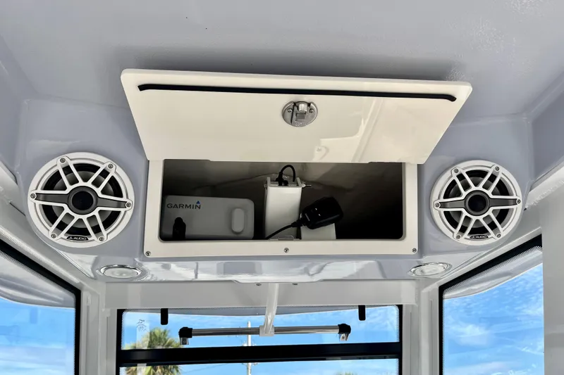 Slide: The Image of 2026 Robalo R270 Center Console with speakers and Garmin equipment storage. - 36