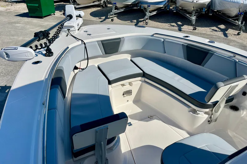 Slide: The Image of 2026 Robalo R270 Center Console boat interior with cushioned seating and trolling motor. - 38