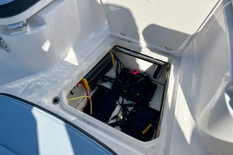 Slide: The Image of 2026 Robalo R270 Center Console boat battery compartment with wiring and equipment. - 42