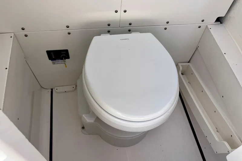 Slide: The Image of 2026 Robalo R270 Center Console boat toilet, compact and efficient marine design. - 46