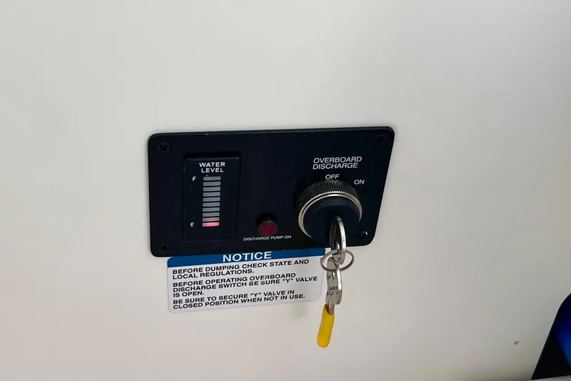 Slide: The Image of Control panel with water level gauge and overboard discharge switch on 2026 Robalo R270 Center Console. - 48