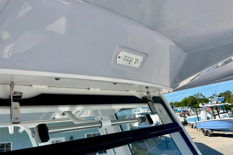 Slide: The Image of 2026 Robalo R270 Center Console boat interior detail with LED light and window mechanism. - 49