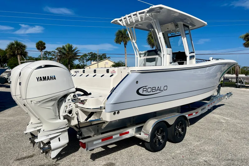 Slide: The Image of 2026 Robalo R270 Center Console boat with Yamaha engines on a trailer. - 6