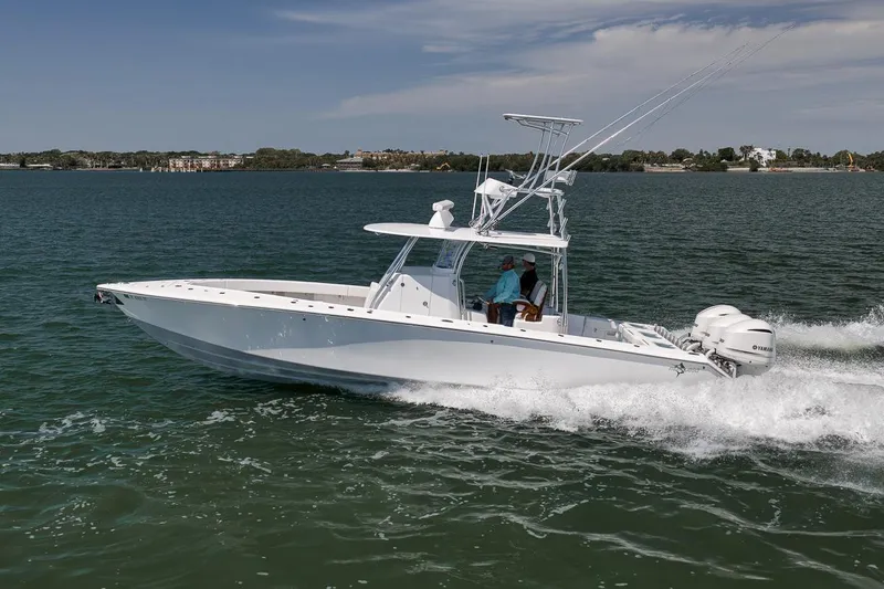 Slide: The Image of 2025 Marquesa 34 boat cruising on a sunny day in open water. - 12