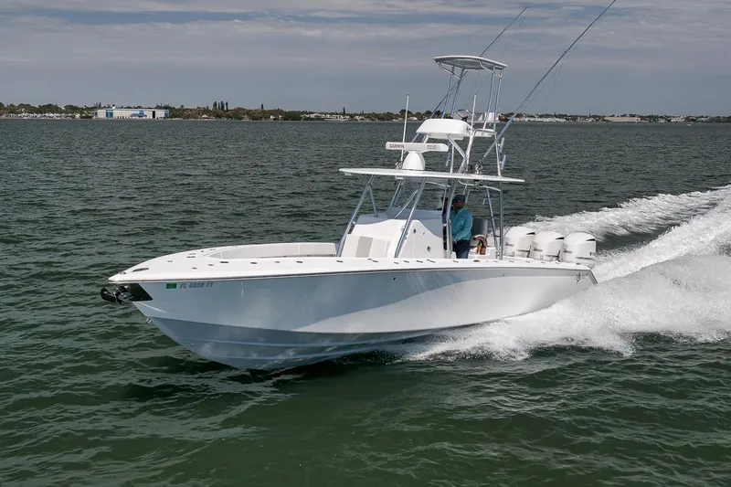 Slide: The Image of 2025 Marquesa 34 boat cruising on open water with triple engines. - 14