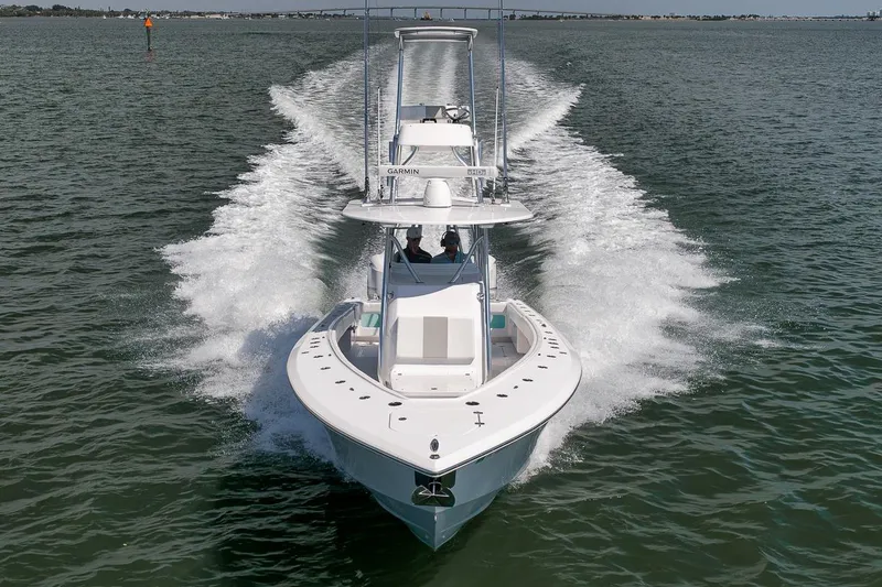 Slide: The Image of 2025 Marquesa 34 boat cruising on open water, creating a wake behind. - 16
