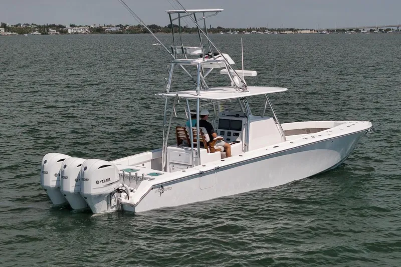 Slide: The Image of 2025 Marquesa 34 boat with triple Yamaha engines on open water. - 17