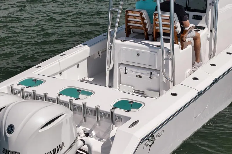 Slide: The Image of 2025 Marquesa 34 boat with Yamaha engines, featuring spacious deck and modern seating. - 18