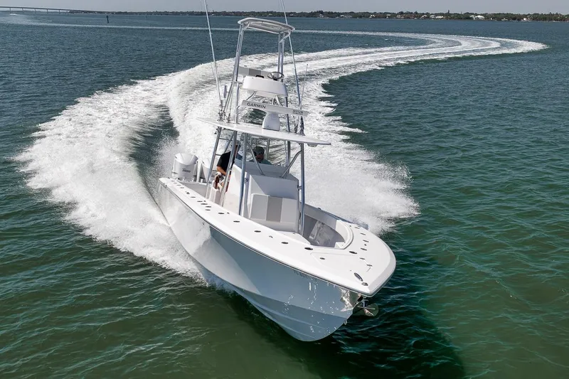 Slide: The Image of 2025 Marquesa 34 boat cruising swiftly on open water. - 2