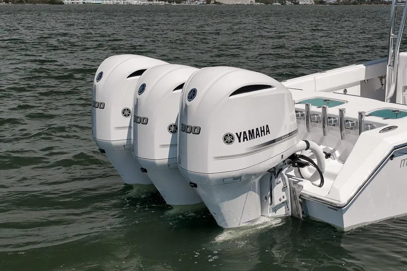 Slide: The Image of Triple Yamaha outboard engines on a 2025 Marquesa 34 boat in water. - 20