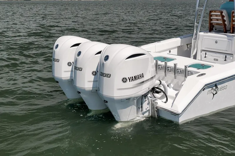 Slide: The Image of Triple Yamaha outboard engines on a 2025 Marquesa 34 boat in open water. - 21