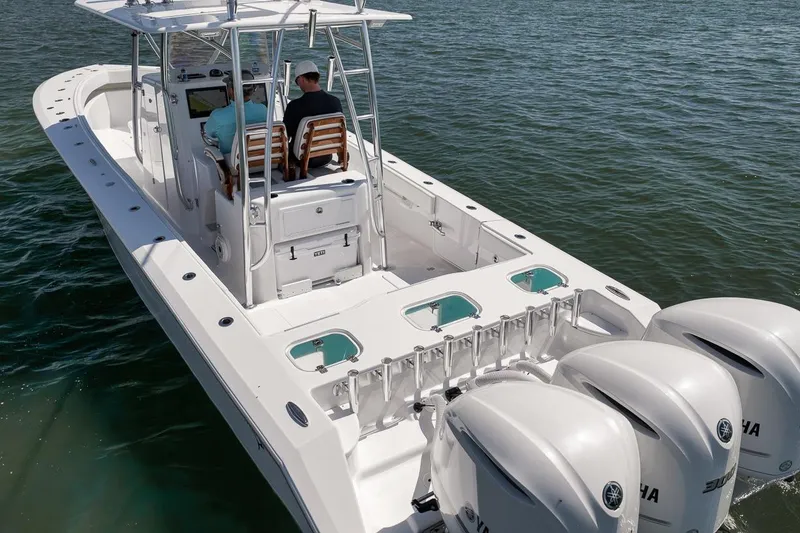 Slide: The Image of 2025 Marquesa 34 boat with triple engines cruising on water. - 22