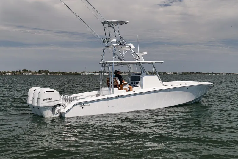 Slide: The Image of 2025 Marquesa 34 boat on water with dual Yamaha engines, clear sky background. - 24