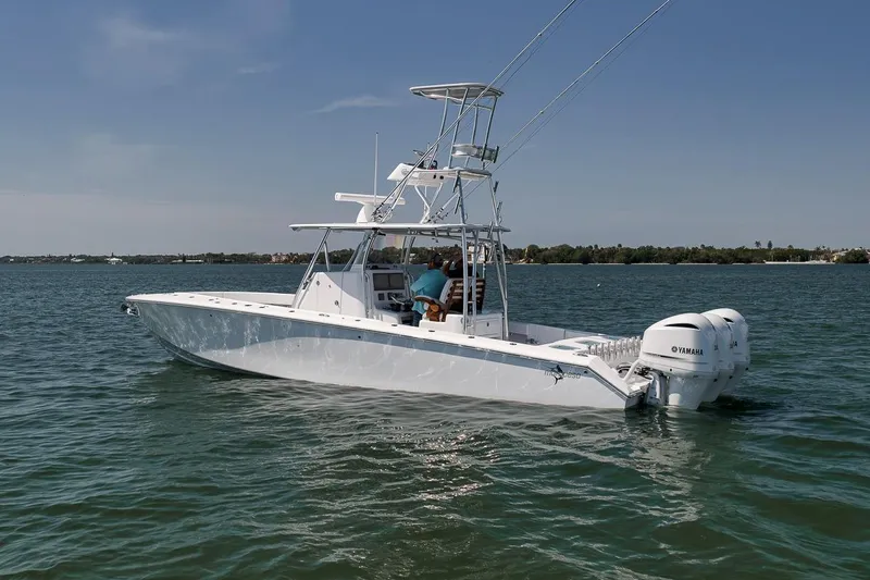 Slide: The Image of 2025 Marquesa 34 boat on water with dual Yamaha engines, clear sky background. - 27