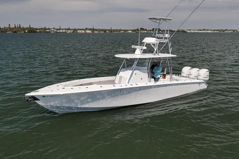 Slide: The Image of 2025 Marquesa 34 boat cruising on calm waters with three outboard engines. - 28