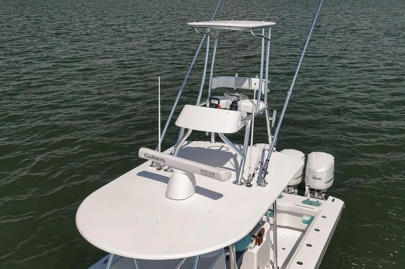 Slide: The Image of 2025 Marquesa 34 boat with dual engines on calm water. - 34