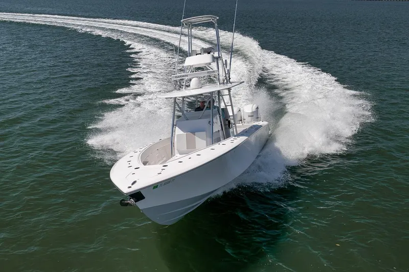 Slide: The Image of 2025 Marquesa 34 boat cruising swiftly on open water. - 4