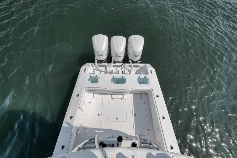 Slide: The Image of Marquesa 34 boat, 2025 model, with triple outboard engines on water. - 40