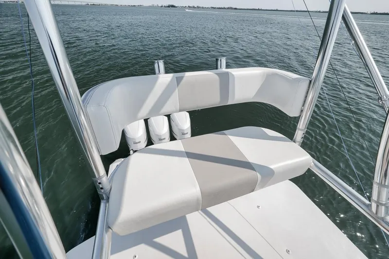 Slide: The Image of Marquesa 34 boat, 2025 model, featuring sleek seating and triple outboard motors on water. - 41