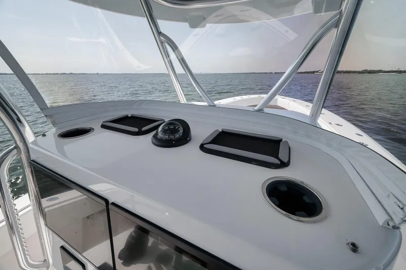 Slide: The Image of 2025 Marquesa 34 boat dashboard with compass, on calm waters. - 46