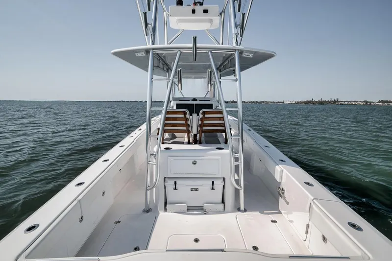 Slide: The Image of 2025 Marquesa 34 boat on open water, showcasing sleek design and spacious deck. - 52