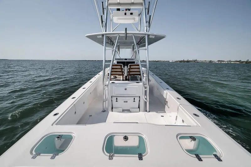 Slide: The Image of 2025 Marquesa 34 boat on open water, showcasing spacious deck and sleek design. - 53
