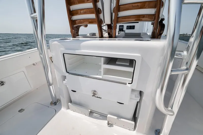 Slide: The Image of 2025 Marquesa 34 boat interior with storage compartments and seating, on open water. - 54