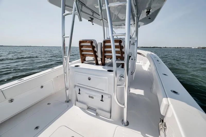 Slide: The Image of 2025 Marquesa 34 boat on water, featuring sleek design and modern seating. - 56