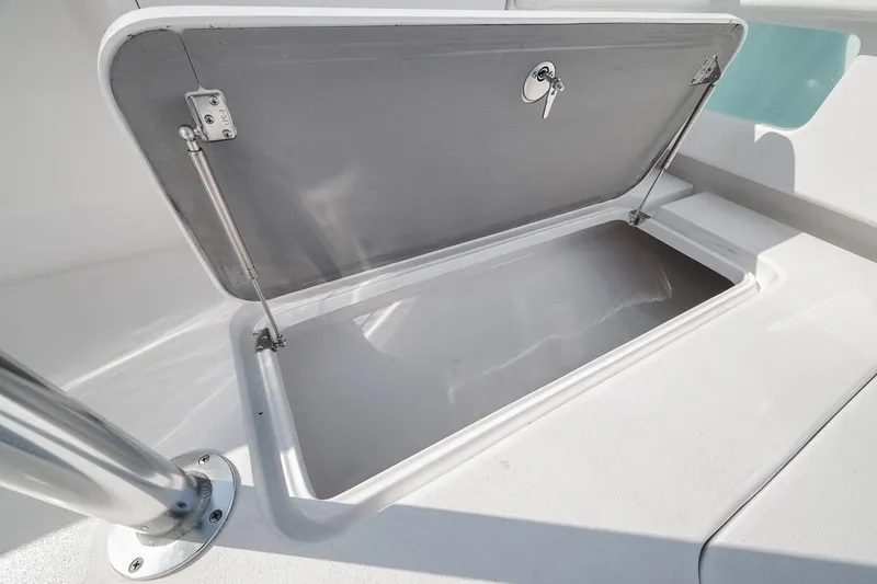 Slide: The Image of Open storage compartment on 2025 Marquesa 34 boat, featuring secure lock and sturdy hinges. - 61