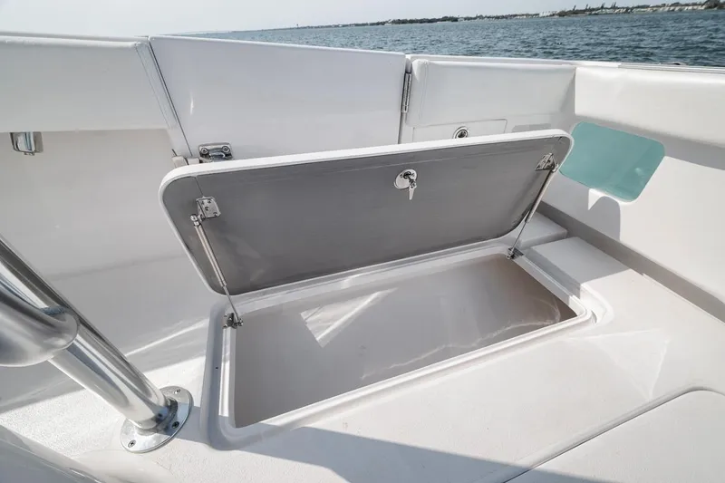 Slide: The Image of Open storage compartment on 2025 Marquesa 34 boat, with ocean view in background. - 62