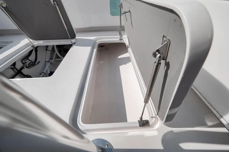 Slide: The Image of Open storage compartment on a 2025 Marquesa 34 boat, showcasing interior details. - 64