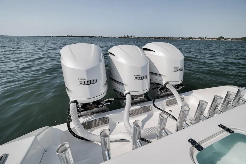Slide: The Image of Triple Yamaha 300 engines on a 2025 Marquesa 34 boat, cruising on open water. - 68