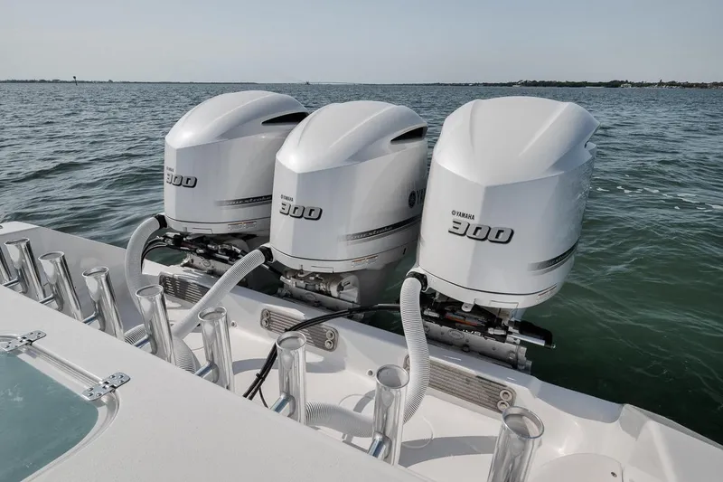 Slide: The Image of Triple Yamaha 300 engines on a 2025 Marquesa 34 boat, cruising on open water. - 69