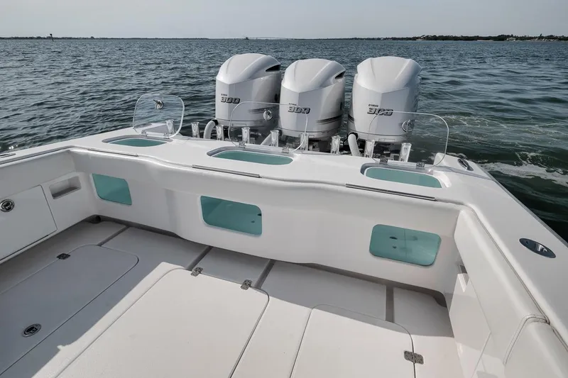 Slide: The Image of 2025 Marquesa 34 boat with triple outboard engines on open water. - 70