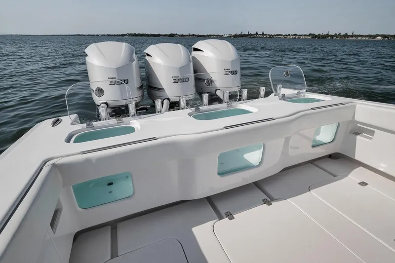 Slide: The Image of 2025 Marquesa 34 boat with triple Yamaha 300 engines on open water. - 71