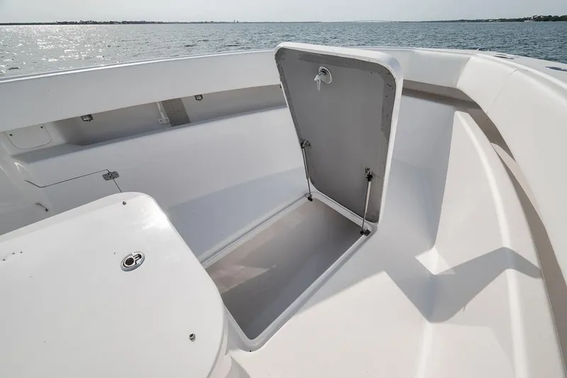 Slide: The Image of Open storage compartment on 2025 Marquesa 34 boat, overlooking calm waters. - 77