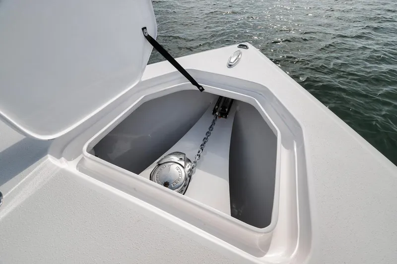 Slide: The Image of Open anchor compartment on 2025 Marquesa 34 boat, showing chain and winch. - 79