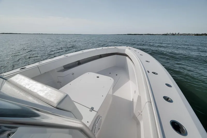 Slide: The Image of 2025 Marquesa 34 boat on calm water, showcasing sleek design and spacious deck. - 81