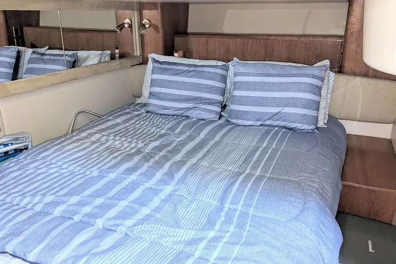Slide: The Image of Interior of a 2004 Meridian 411 Sedan yacht, bed with blue bedding. - 30
