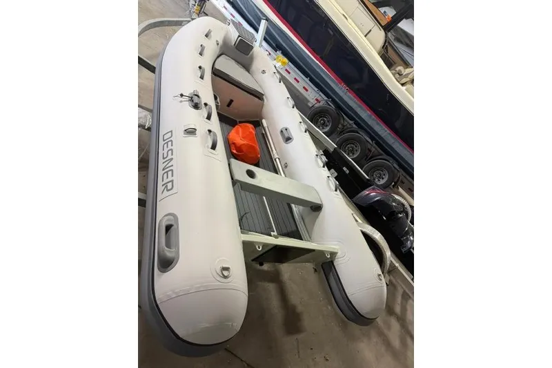Slide: The Image of Inflatable Desner CL340 boat, 2026 model, in a garage setting. - 3