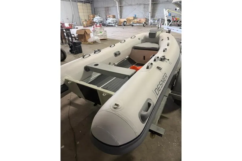 Slide: The Image of Inflatable Desner CL340 boat in a warehouse, 2026 model. - 4