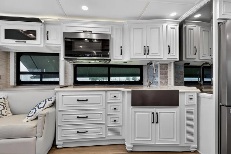 Slide: The Image of Luxurious kitchen interior of 2025 Newmar Dutch Star 4340 RV with modern cabinetry. - 13