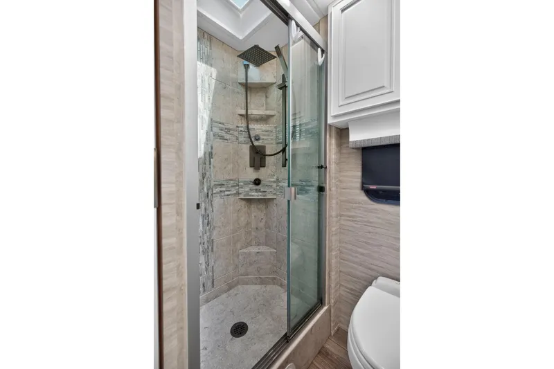 Slide: The Image of Luxurious shower in 2025 Newmar Dutch Star 4340 RV, featuring modern glass doors and elegant tile design. - 21