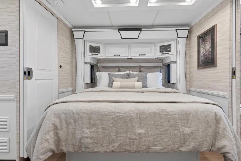 Slide: The Image of Luxurious bedroom interior of 2025 Newmar Dutch Star 4340 RV with elegant bedding. - 23